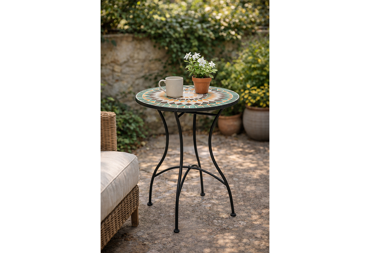 Απεικονίζεται το τραπέζι σε εξωτερικό χώρο με μια κούπα και μια γλάστρα πάνω.